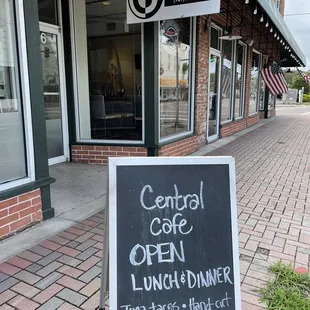 a blackboard sign on the sidewalk