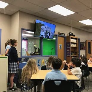 Older students presenting stories of missionaries to younger students