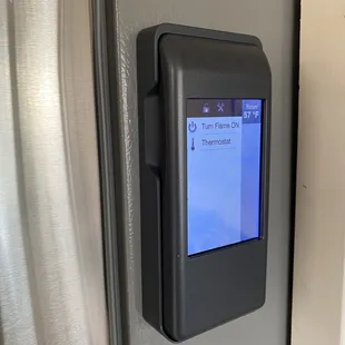 Slick remote control which also acts as the thermostat. Magnetic so can sit on the fridge...