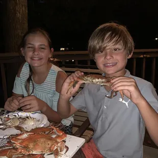 two children eating crab
