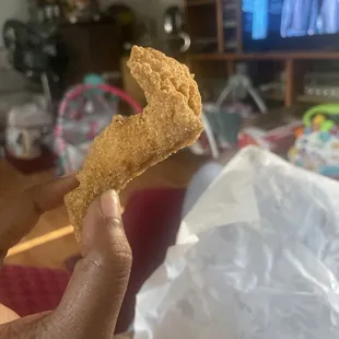 Dry cat fish shouldn't even be able to stand up like this when held straight up. And then compare the length of my thumb to this fish smh!!!