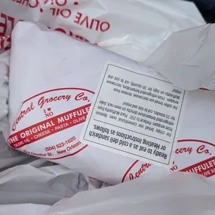 Half a muffaletta sandwich pre-made, wrapped and ready to go