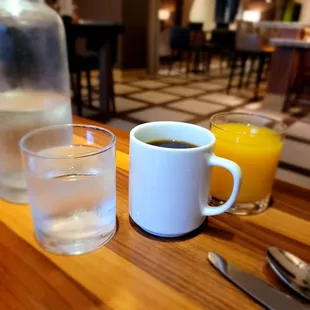 a cup of coffee and a glass of orange juice