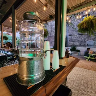 an ice bucket and two bottles on the bar