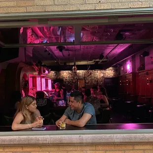 two people sitting at a bar