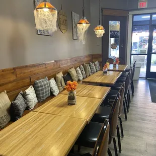 a long wooden table with black chairs