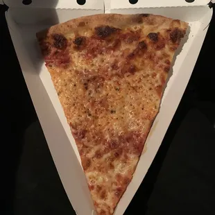 a slice of cheese pizza in a box