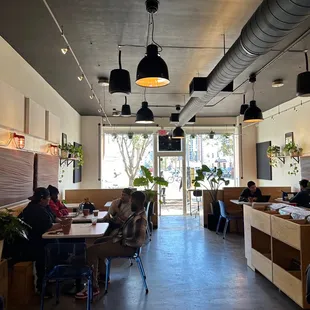 people sitting at tables in a restaurant