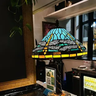 a stained glass lamp on a marble countertop
