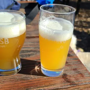 two glasses of beer on a table