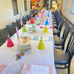 a long table set for a birthday party