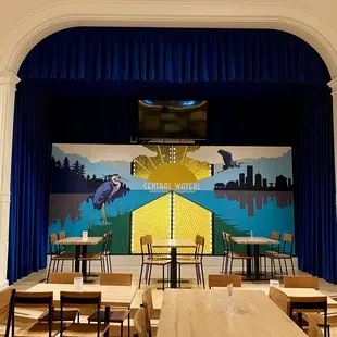 a stage with tables and chairs