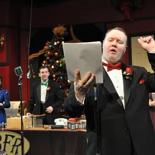 a man in a tuxedo singing