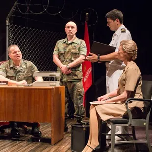 a group of military personnel sitting at a table