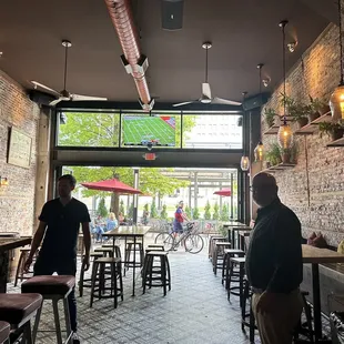 a man and a woman standing at a bar