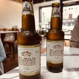 two bottles of beer on a table