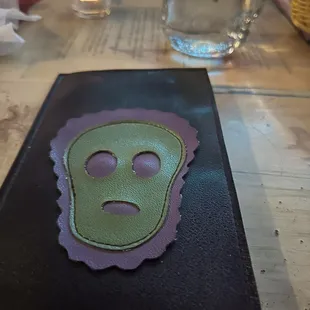 a green and purple mask on a table