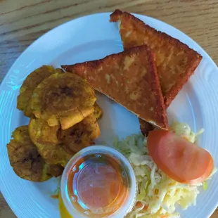 Fried plantains with fried cheese and a salad