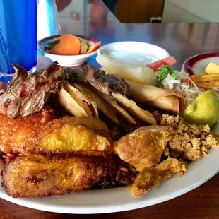 WHAT BOUNTY! The $15 sampler has pork, beef, plantains, fried cheese, rice, beans and a lot of tasty food I have no idea what it is.