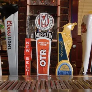 a row of beer taps on a bar