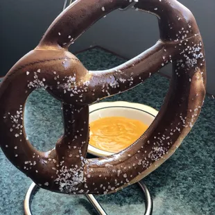 a pretzel with a bowl of soup