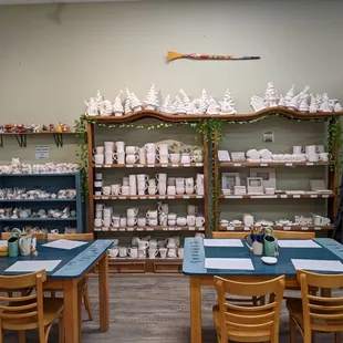 Craft tables and one of the racks filled with pieces you can buy to paint.