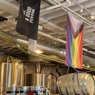 a rainbow flag and barrels of beer