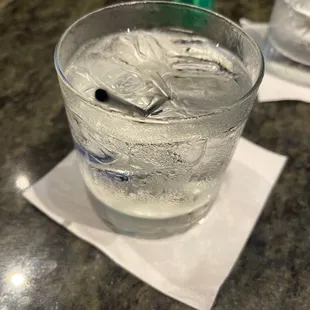 a glass of water with a spoon in it