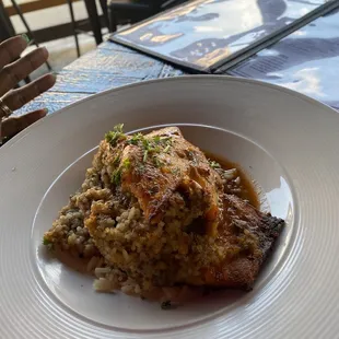 Boudin stuffed salmon on a bed of dirty rice