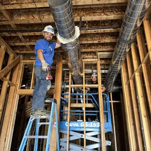 HVAC ductwork installation new construction site.