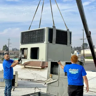 Crane set multiple unit replacements at a commercial building.