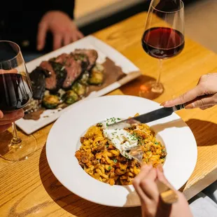 a plate of food and a glass of wine