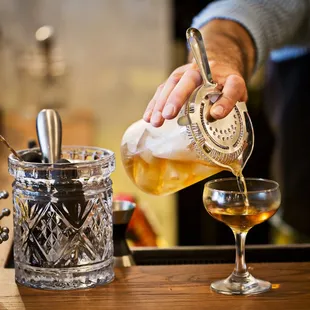 a bartender pouring a drink