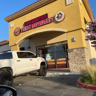 a truck parked in front of a restaurant