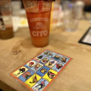 a drink and a card on a table