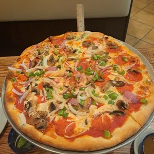 Pepperoni Pizza w/ red onions, green peppers, and  mushrooms.