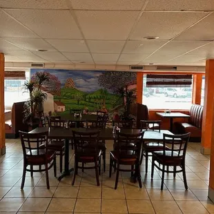 a dining area with tables and chairs