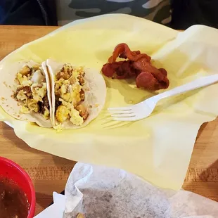 Potato and cheese breakfast tacos with a side of bacon.