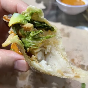 a person holding a piece of food
