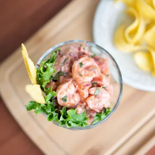 a plate of chips and a bowl of shrimp