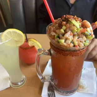 Skinny margarita on left, strawberry margarita, Michelada ceviche on right
