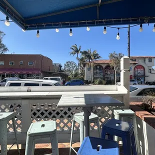 a patio area with blue chairs