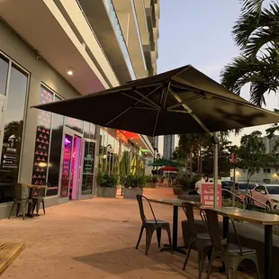 a patio area with tables and chairs