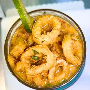 Leche de Tigre Mercado, With Leche de Tigre de Pescado en Ají Amarillo and Crunchy Calamari, we guarantee an explosion of flavor.