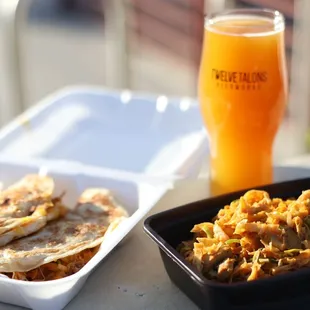 a plate of food and a glass of beer