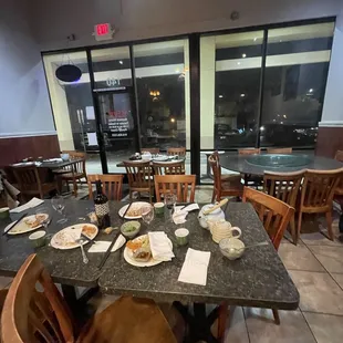 a restaurant with tables and chairs with food on them