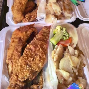 a tray of fried fish and vegetables