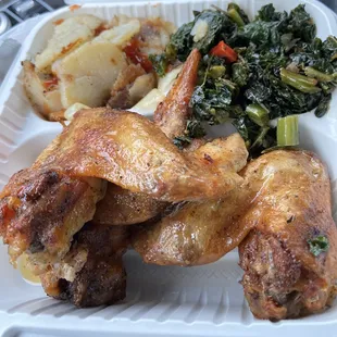 Baked chicken wings with fried potatoes and sautéed kale