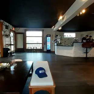 Spacious. Old home refurbish. Another couch. Bistro tables and bar seats along windows. More tables towards back.