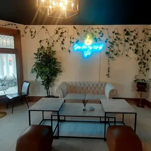Parlor. Bistro tables and couch. Love real plants.